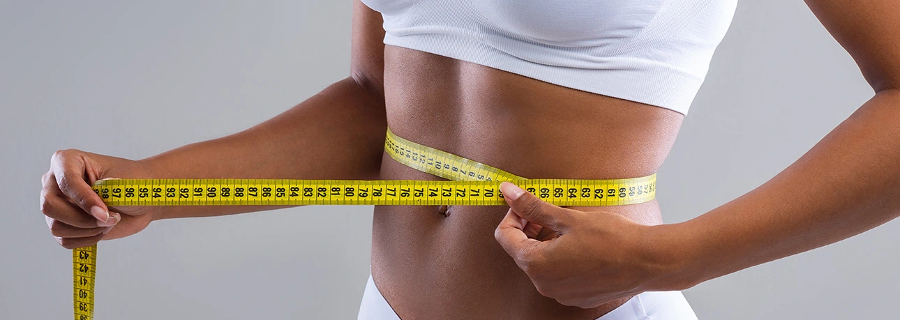 Measuring waist size during a weight loss consultation