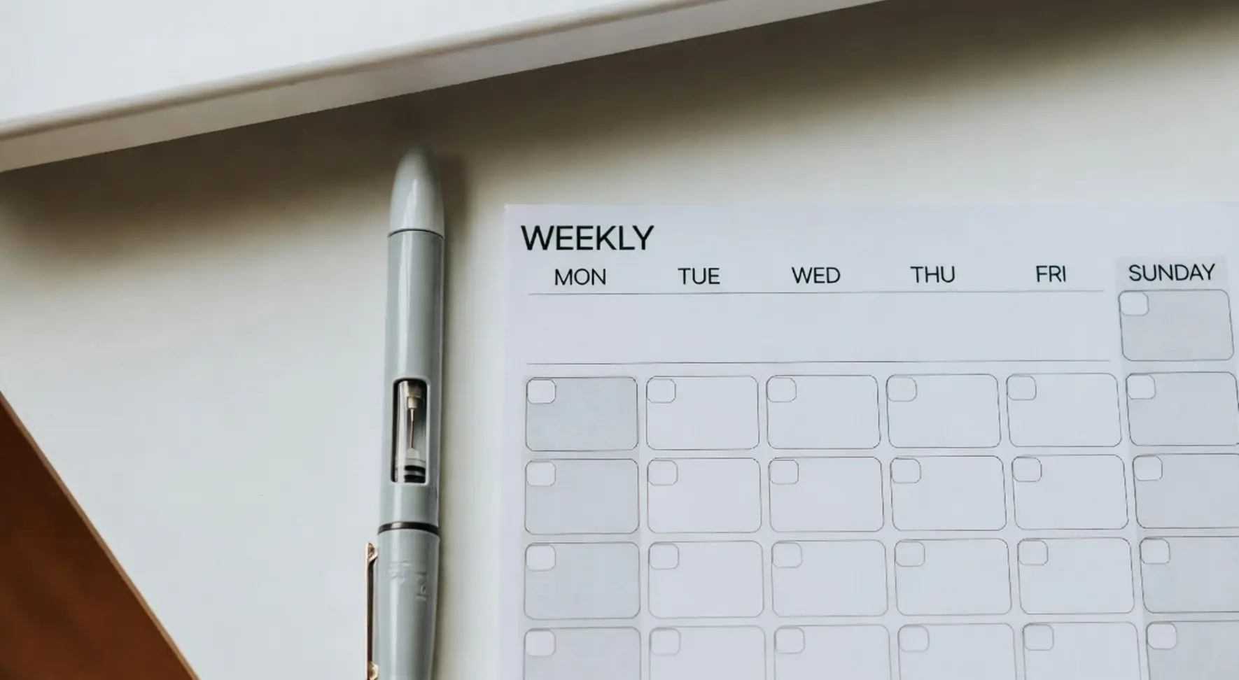 Pre-filled injection pen next to a weekly dose schedule for weight loss treatment