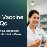 A female pharmacist smiling while holding a syringe to administer a vaccine to a male patient in a pharmacy, next to text reading "Flu Vaccine FAQs Everything Manchester Residents Need to Know" on a dark teal background.